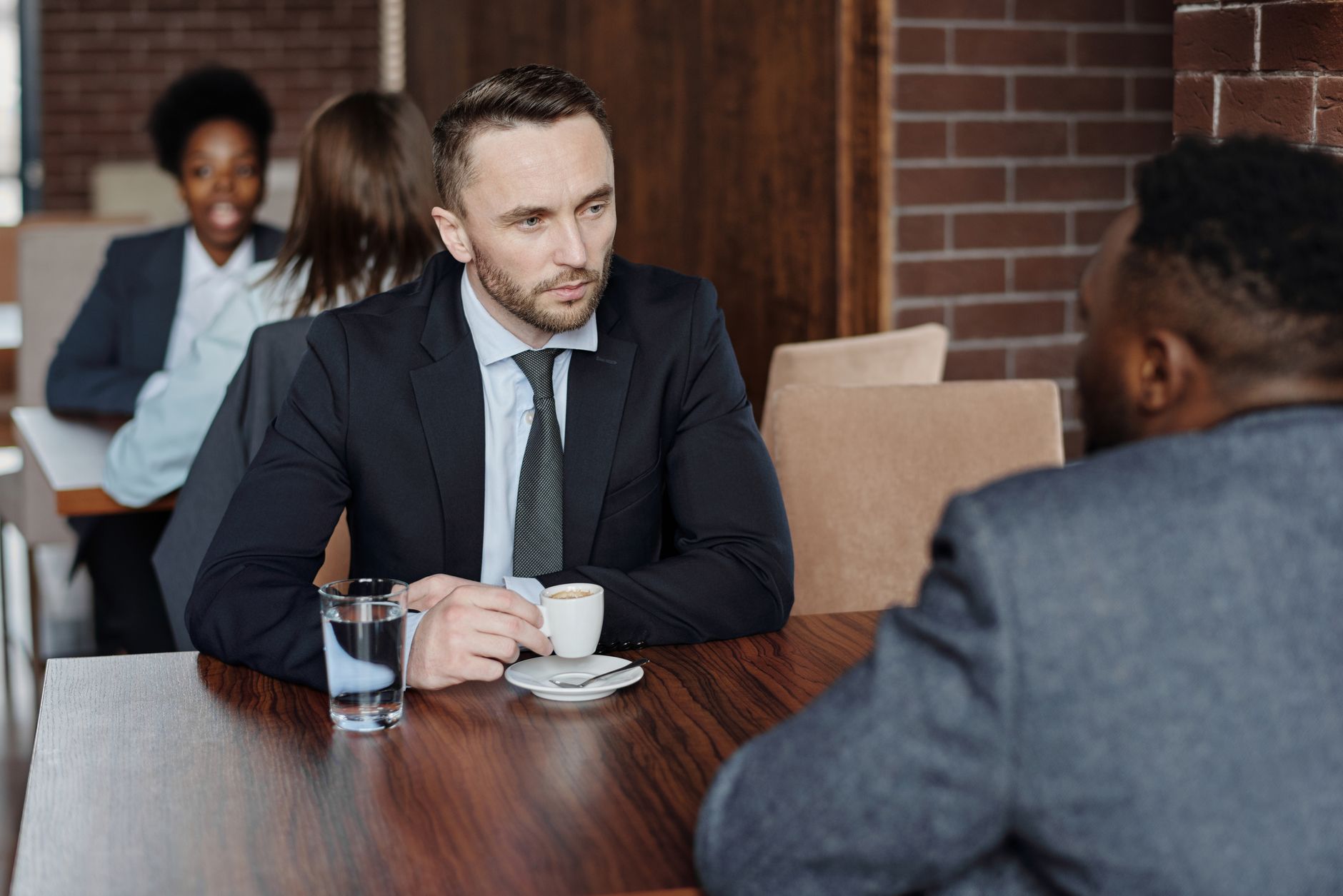 Two people talking across a café table
